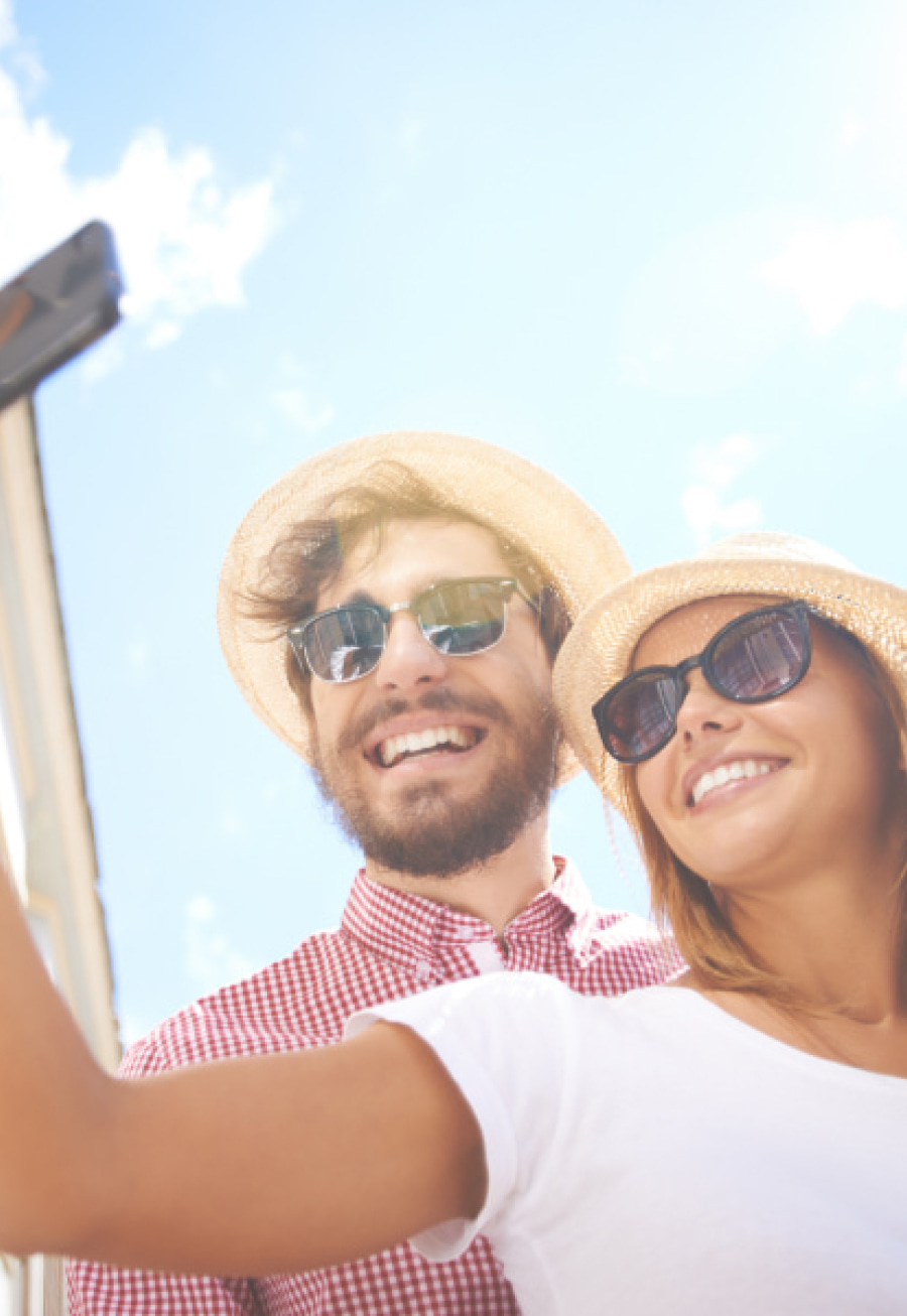 A couple wearing sun glasses are smiling